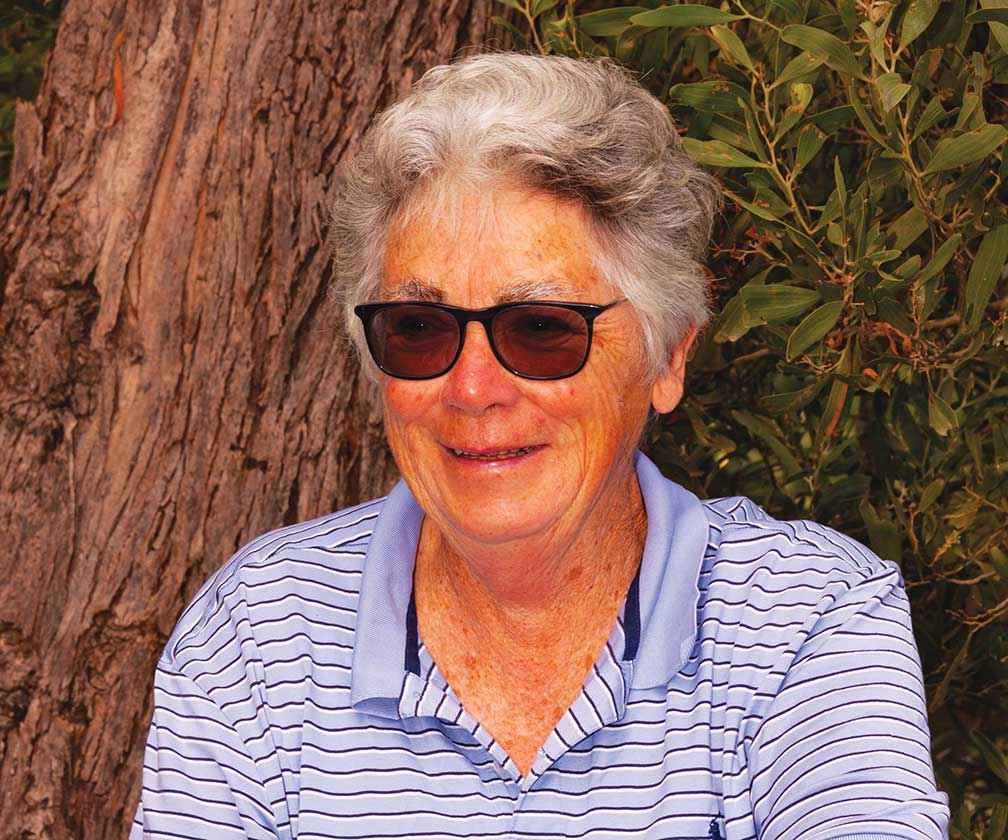 Pam Cunningham, a stalwart in the local community, in front of a messmate on her property. Fortunately, the house was saved.
