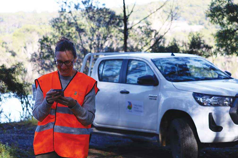 Volunteer Kirsten Boehm, an aspiring lepidopterist, looks over the project methods at the Mallacoota training day on Bidawal Country in 2021.