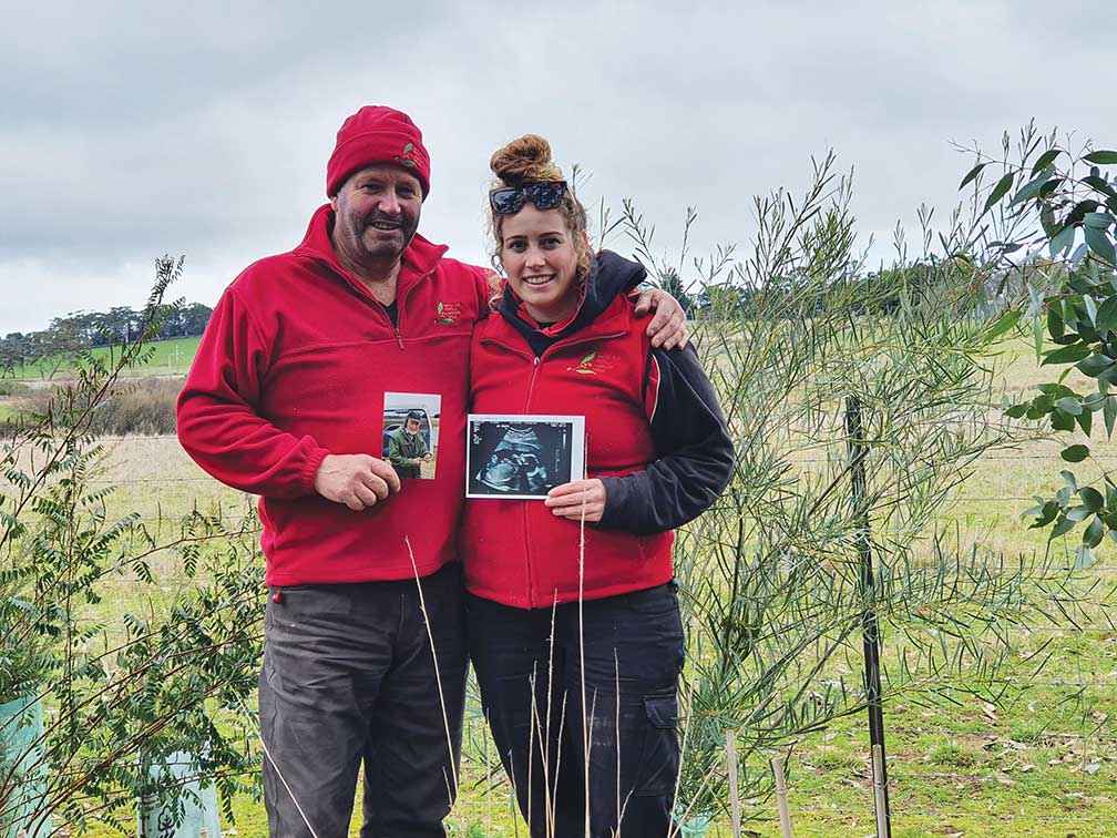 Four generations of the Martin family: Andrew holding a photo of his father David and his daughter Kate holding a photo of her recent baby scan.