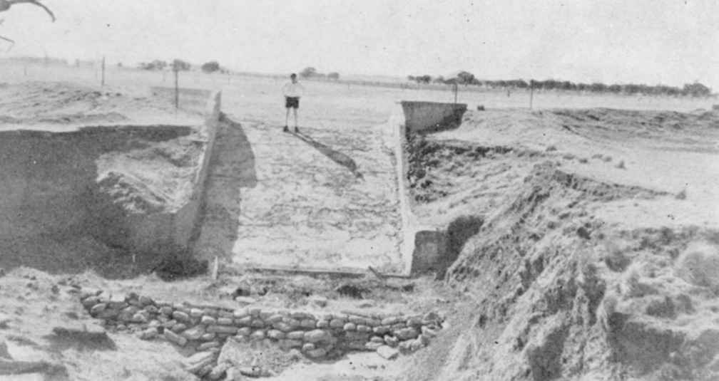 Geoff Henderson stands on the concrete chute he built to control runoff on the property in the mid-1950s.